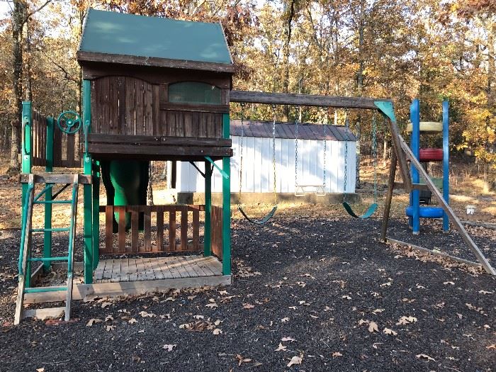 Playset by Leasuretime Products.   Includes slide, 3 swings, treehouse, sand box.  Will need to be removed.