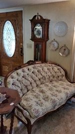 Antique parlor sofa/love seat.  Grandfather clock.