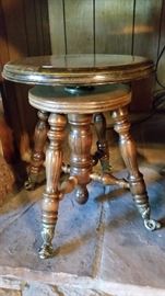 Antique glass ball in claw piano stool.