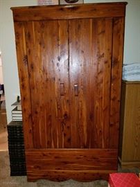 Armoire with bottom storage section 