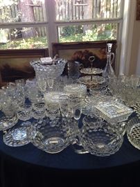 Large array of Fostoria Americana including a punch bowl, underplate, ladle, and cups