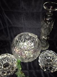 Some of the numerous rose bowls, candle holders, and vases