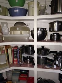 A pantry full of pots, pans, cookbooks, and small appliances