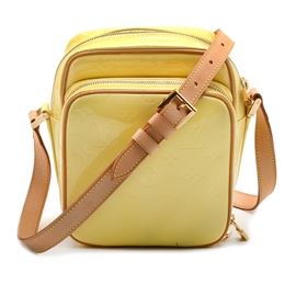 Louis Vuitton Vernis Wooster Crossbody Bag: A Louis Vuitton Vernis Wooster crossbody bag. This patent leather bag in a warm lemon yellow monogram print features two compartments with gold toned zippers and is finished with a soft leather, adjustable strap.