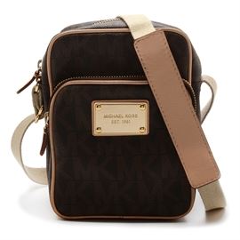 Michael Kors Signature Crossbody Bag: A Michael Kors signature crossbody bag. This bag is printed in a MK monogram print and features two zippered pouches, an adjustable canvas strap with leather shoulder rest, and a high-shine “Michael Kors Est. 1981” plaque to front. Handbag bears embossed leather “Michael Kors” tag to interior.