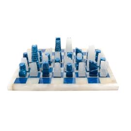 Carved Agate Chess Set: An agate chess board with hand-carved pieces. This set features square dyed blue agate and white agate game board with coordinating game pieces. Unmarked.
