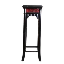 Wood and Rattan Plant Stand: A black painted and rattan plant stand. The top features a square rattan panel set in a black painted tiered frame. The apron repeats the same rattan with an edge of trim. The stand rests on four legs that turn out slightly at the floor with a box stretcher.