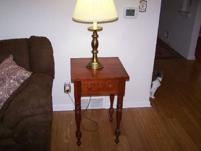 ONE OF A PAIR OF CHERRY ONE-DRAWER STANDS, BRASS LAMP