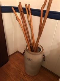 4 gallon 2 handled crock with vintage walking sticks and canes.