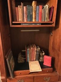 Thomasville Entertainment Center with antique books, and part of the collection of book ends. 