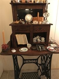 Wrought iron Singer sewing machine base table with an antique oak children's sideboard on top.  Plus a collection of Peter Rabbit Books, miniature tea sets, Dutch houses and much more.