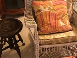 Wicker rockers and antique ball and claw footed piano stool.