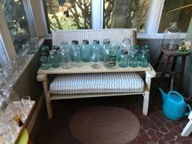 Vintage porch furniture with blue Mason jars.