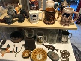 Horse brasses, steins, moustaches cups, a spur, carved bears.