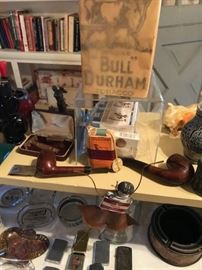 Bull Durham tobacco, pipes, gold Gilette razor in case, ash trays.