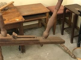 Antique and vintage tables and plant stands in the shed.  Plus the bottom of an antique spinning wheel.