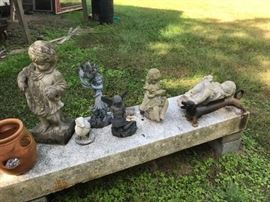 Lots of lawn art, granite and stone benches.  Note the cast iron dachshund boot scraper.