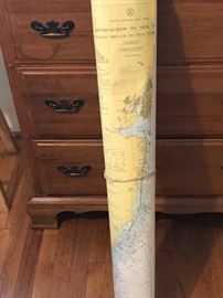 Set of NC Coast Navigation charts leaning on the cherry Welsh Valley Thomasville chest of drawers.