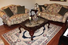 Sofa, loveseat, coffee table, side table, area rug, candlesticks, lamps