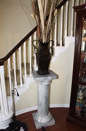 Marble pedestal, floral arrangement, display case