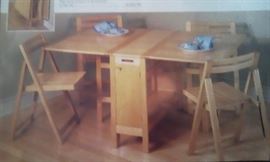 Disappearing table with 4 chairs.  Great for apartment or small space.