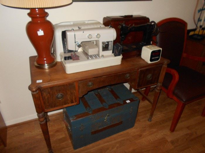 beautiful desk antique chest , antique sewing machine and newer sewing machine