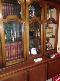 Large 3-door cabinet loaded with leather bound books and decor