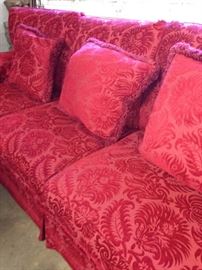 The extra large red sofa has a matching love seat, over-sized chair, and ottoman.