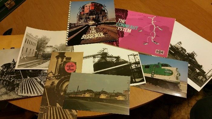 Large collection of train photos, pictures, and paper items.