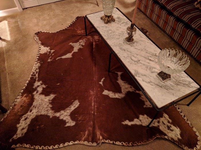 No matter what you may think, this is not road kill, but rather a whipstiched cow hide from Brazil.                         Not the country, but after a night a drunken stupor, I went dumpster-diving at my neighborhood Fogo de Chão, found this and threw it on the floor - voila! 
