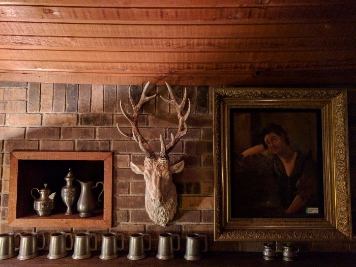 Now here's something you won't see everyday. A resin deer head, flanked on the left by a collection of vintage pewter and on the right by a beautifully framed oil portrait of a very homely woman, BUT it's from the Wrigley estate.