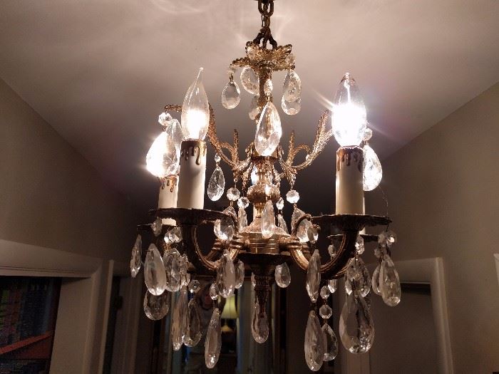 There are several of these vintage Spanish chandeliers throughout the house, all for sale. They have all of their crystals, and no spiders.