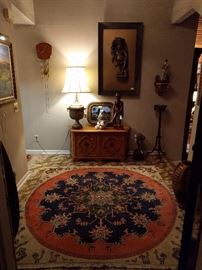 Beautiful entry, with vintage Persian rug in all the correct colors, Heritage console, Junghans wall clock, Vishnu God-Thing artwork, MCM bald egret sculpture,  hand carved wooden Balinese fisherman, Victorian wooden plant stand, Asian cloisonne queen and a pair of original oil paintings, all marry for a visual feast as you enter the front door.