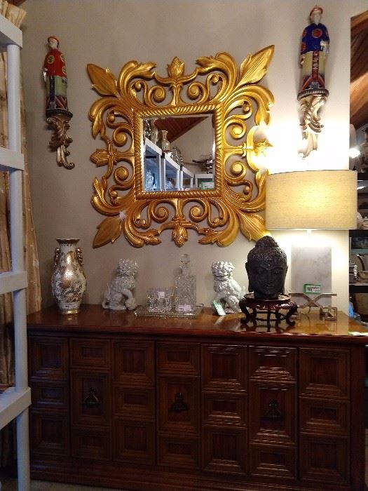 Nice gilt wood, beveled glass wall mirror, on the buffet that matches the Drexel Esperanto suite. There's a stone Buddha head, a pair of Rosenthal-Netter foo dogs, Waterford crystal aperitif glasses and a very heavy, solid marble Surya "Kerrigan" lamp, that retails for over $400.00 - yep, just ask the Google.
