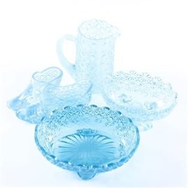 American Patterned Glass "Daisy and Button" Assortment: An assortment of aqua American glass Daisy and Button decor. Featured is a pair of shoes, a footed bowl with scalloped rim, a water pitcher and a scalloped rim bowl with ruffled feet. The assortment has no manufacturer’s marks.