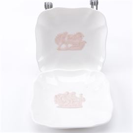 Wedgwood "Pink-On-Cream" Queensware: A group of two Wedgwood Pink-On-Cream Queensware trays. These trays feature central pink figural motifs on a cream body decorated with a delicate, scalloped edge. They are marked to the underside, “Of Etruria & Barlaston, Made in England, Wedgwood Embossed Queensware”.