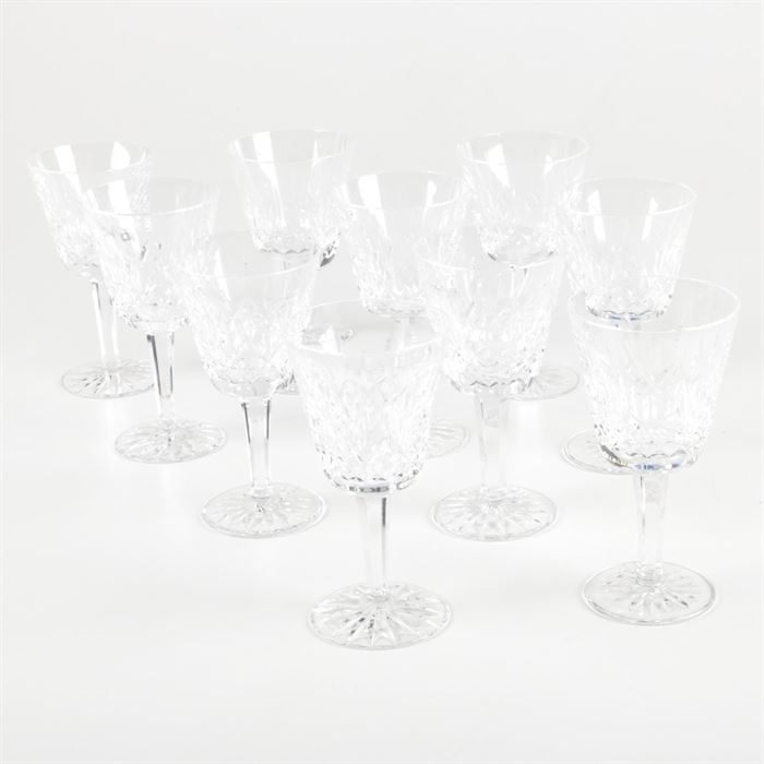 Waterford Crystal "Lismore" Goblets: A set of ten Waterford Crystal goblets in the Lismore pattern. Each piece is decorated with cross-hatch and vertical cuts to the bowl. They feature multisided stems and round bases decorated with starburst motifs. Each piece is etched “Waterford” to the underside.