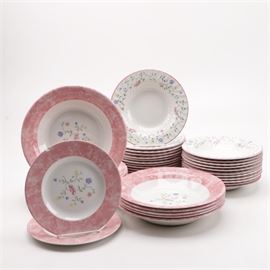Johnson Bros. "Summer Chintz" Tableware: A set of Johnson Bros. Summer Chintztableware.This set of earthenware from Johnson Bros. is presented in the Summer Chintz pattern with pink rim, floral sprays on a white field. This approximately thirty-seven piece set includes two 8.25" salad plates, eleven 10.25" bowls, twenty-four 8.5" bowls.The base is marked to the underside “Johnson Bros. Made in England, Dishwasher and Microwave Safe.”