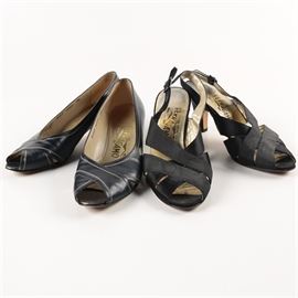 Women's Salvatore Ferragamo Dress Shoes: A selection of two pairs of women’s Salvatore Ferragamo dress shoes, both in a size 7 B. This grouping includes a pair of navy blue leather pumps with crossed straps at the peep toes, top stitched trim and 1.75" heels. Also included, a pair of black slingbacks with grosgrain ribbon vamp straps, black matte satin adjustable ankle strap and 3" heels. Each pair are stamped to the interior by the manufacturer.
