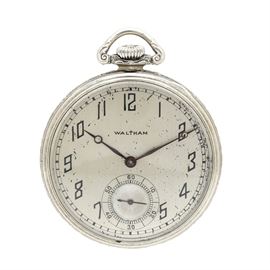Vintage Waltham Gold Filled Pocket Watch: A vintage Waltham gold filled pocket watch. This pocket watch features a dial with black Arabic numeral hour indicators and a sixty second dial at the six o’clock position, accented by breguet moon styled hands. The back of the case showcase a textured surface with an engraved swirling motif.
