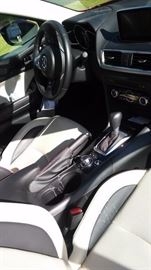 2016 Mazda 3.   6,400 miles. Loaded with everything