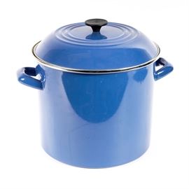 Le Creuset Enameled Soup Kettle: A Le Creuset enameled metal soup kettle. The kettle has a round shape, and includes a lid with black knob, and the kettle has enameled metal handles on the sides. The knob is marked “Le Creuset”.