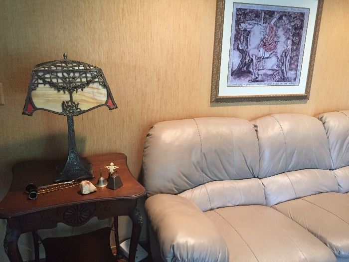 "Tiffany" lamp on Mahogany table next to reclining leather sofa