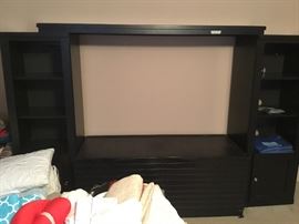 Black wall unit in bedroom