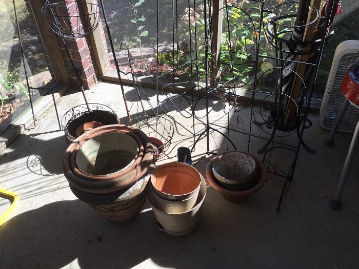 Planter stands, flower pots on screen porch
