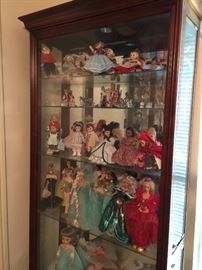 Glass curio cabinet and dolls
