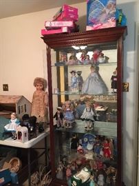 glass curio cabinet and dolls