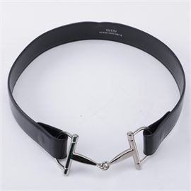 Gucci Black Leather Belt: A Gucci Black leather belt. The Gucci design includes a smooth black leather belt strap with adjustable eyelets and a two part silver tone gancio horse bit buckle set to the end. Markings to the underside include “Gucci Made In Italy” and " 80-037-1391-1927-5".