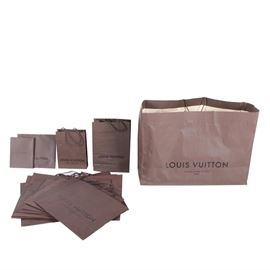 Louis Vuitton Shopping Bags: A collection of thirteen brown Louis Vuitton shopping bags. The collection includes a flat box, a large shopper and various other small to medium sized shoppers. Each features a brown finish to the exterior of the bag with black lettering and a cream tone interior. Each is marked Louis Vuitton, Maison Fondée en 1854, Paris and other than the flat box, each features rope handles.