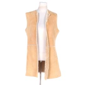 Women's Suede and Shearling Vest: A women’s suede and shearling vest. This collarless, tan suede vest features an open front, shearling trim and a shearling lining.